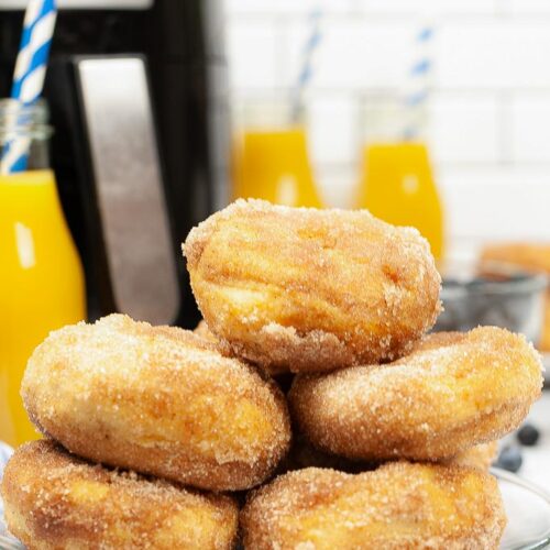 Biscuit Donuts in Air Fryer shown baked and coated in sugar on a plate.