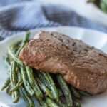 A air fried steak piled on green beans.