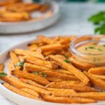 A close up of air fried sweet potato fries on a plate.