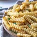 A close up of air fried crinkle cut fries.