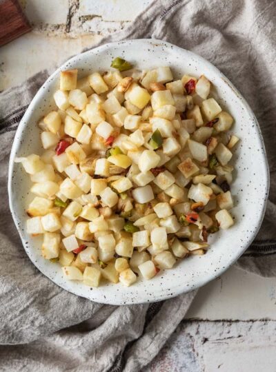 Home fries after air frying in a bowl shown close up.