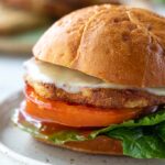 cheesy turkey burger on a bun with lettuce and tomato
