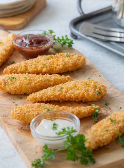 fully cooked and reheated chicken tenders on a serving board