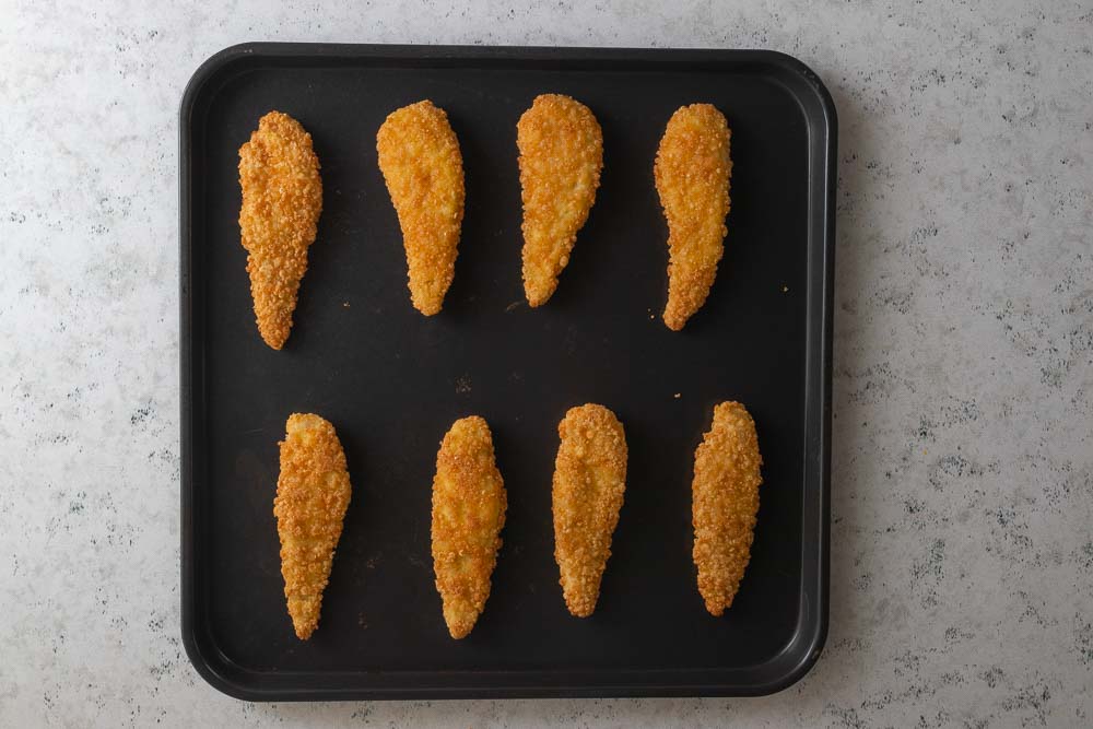 8 chicken tenders on an air fryer tray