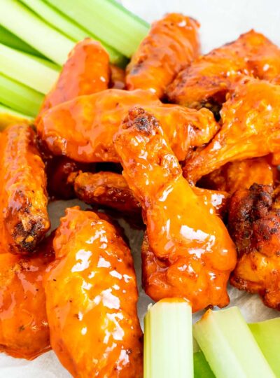 Chicken wings cooked and covered in buffalo sauce served with raw veggies.