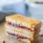 2 sliced of PBJ, cooked on parchment.