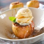 air fryer baked apple in a bowl with ice cream on top
