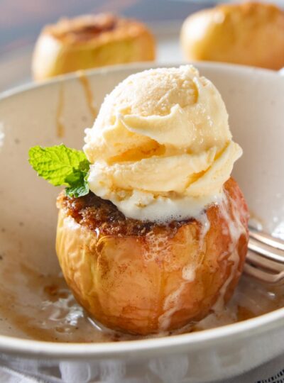 air fryer baked apple in a bowl with ice cream on top